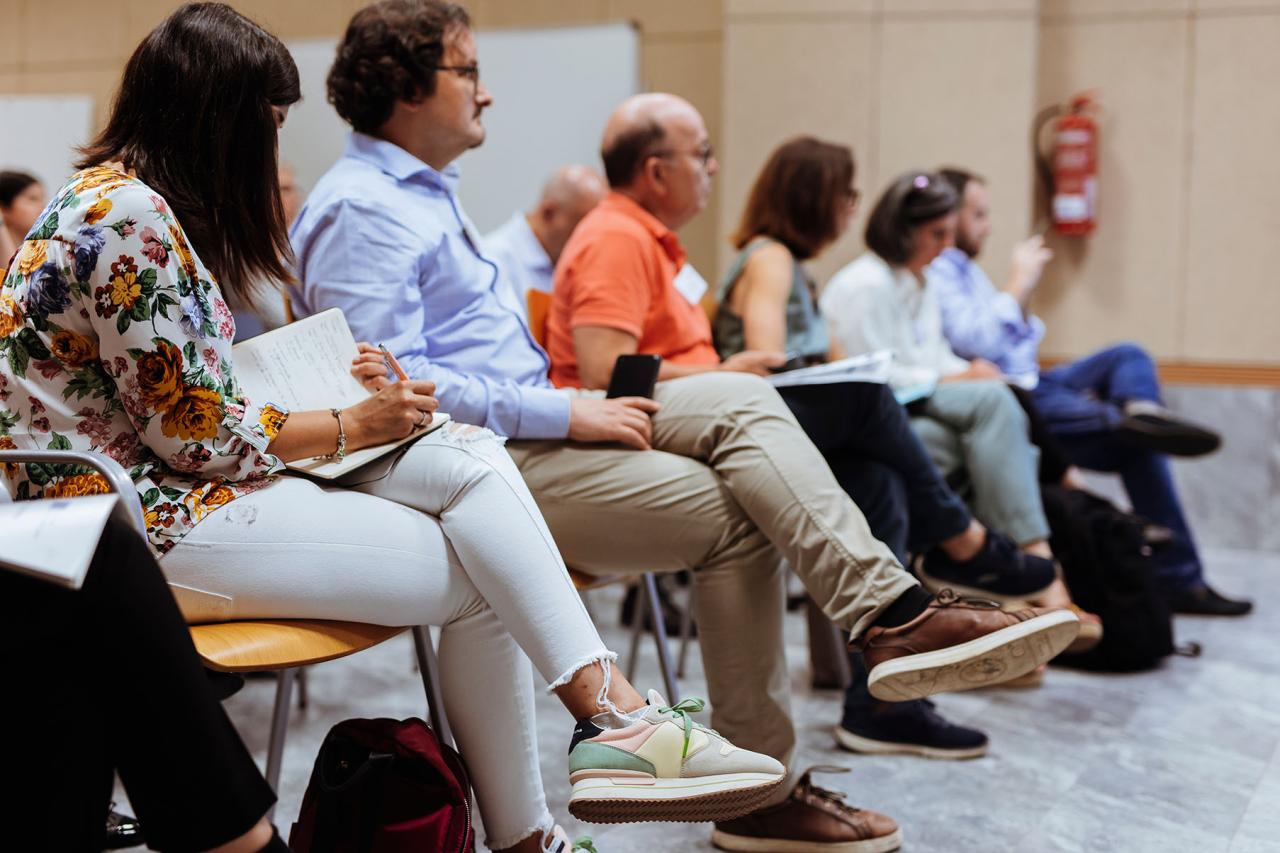 Participants taking notes on a presentation discussing vaccines