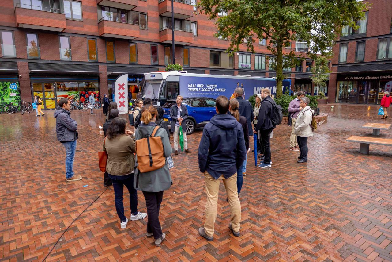 Participants gathering in front of mobile vaccination units.